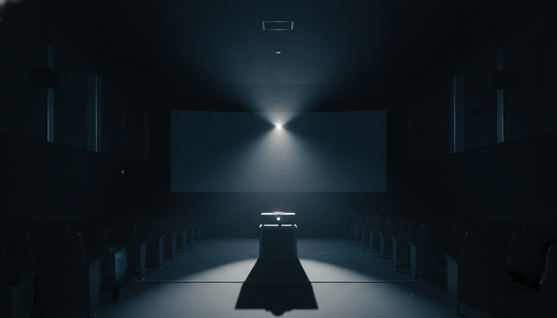 Karanlık bir sinema salonunda projeksiyon ışığı toza karışıyor